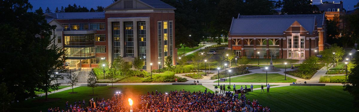 uconn landscape 2 aerial view of uconn students outside in front of campus buildings during the night